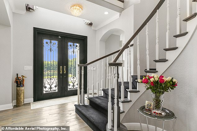 Pictured: The $25,000 front door was made with hurricane-resistant glass and a decorative wrought iron grille.