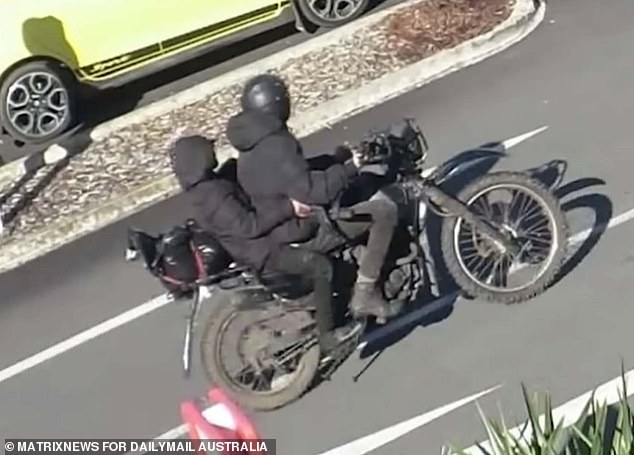 Pictured: Two people on a motorcycle, who police say were Phillips and his daughter after allegedly robbing an ANZ bank.