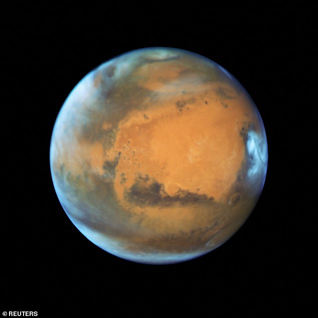 Ice sheets that could support life on Mars were formed by dusty blizzards over dozens of ice ages that hit the Red Planet over the past 5 million years. Above: A May 12, 2016 NASA image taken with the Hubble Space Telescope showing the visible cloud cover of Mars