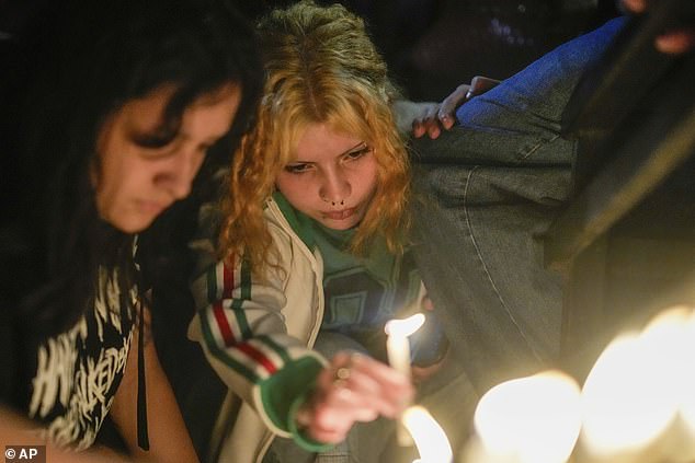 Fans light candles outside the hotel where former One Direction Payne was found dead