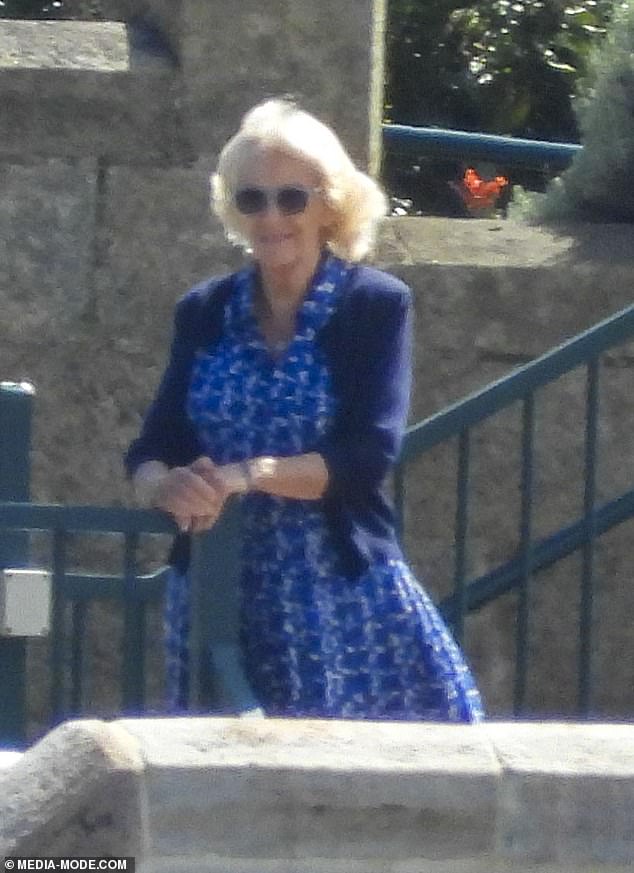 Camilla opted for a dark blue summer dress and matching cardigan.