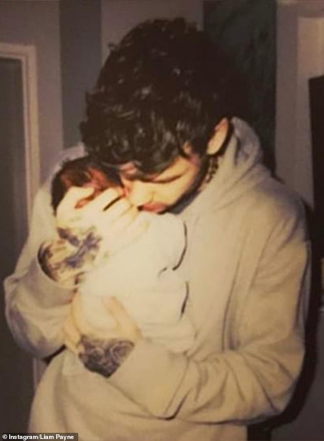 Liam holds his then-newborn son, Bear, in his arms in March 2017, as if he were the most precious thing in the world.