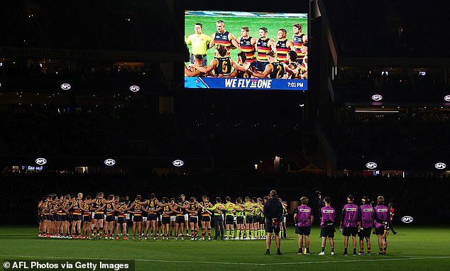 AFL players, coaches and referees observed a minute's silence in honor of victims of gender-based violence against women on August 30, 2024 (pictured: Round 08 match in Adelaide)