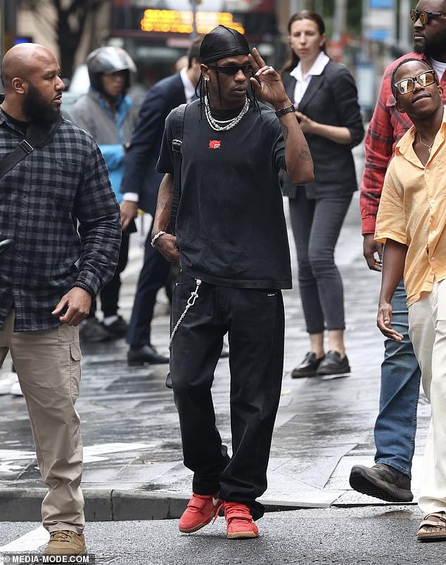 For the outing, Travis cut a relaxed figure in a black t-shirt and baggy pants as he was seen greeting fans.