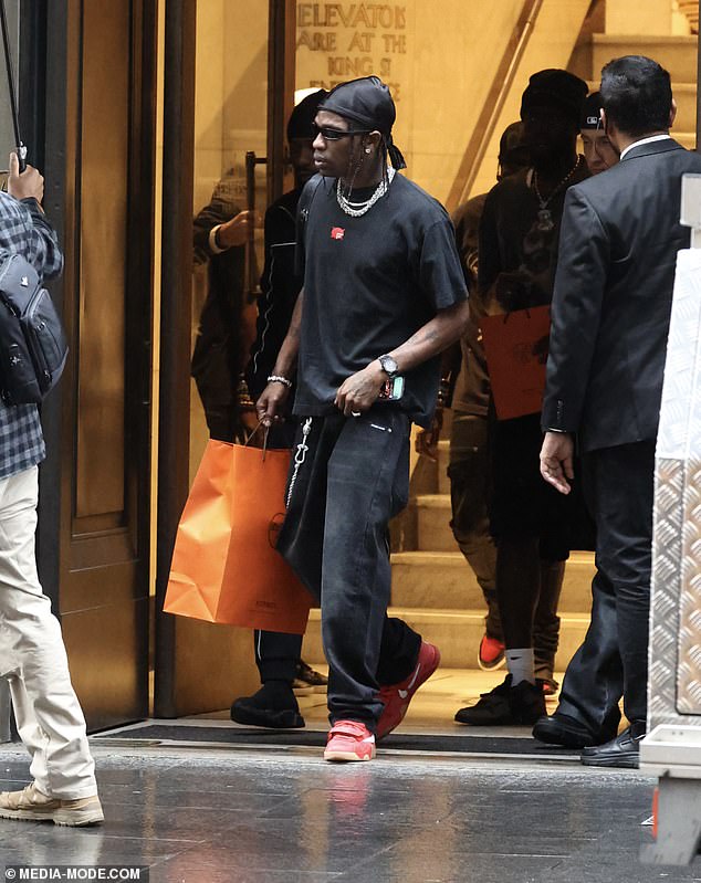 Travis seemed to have had a successful shopping trip as he was seen leaving the Hermes store with a large orange bag.