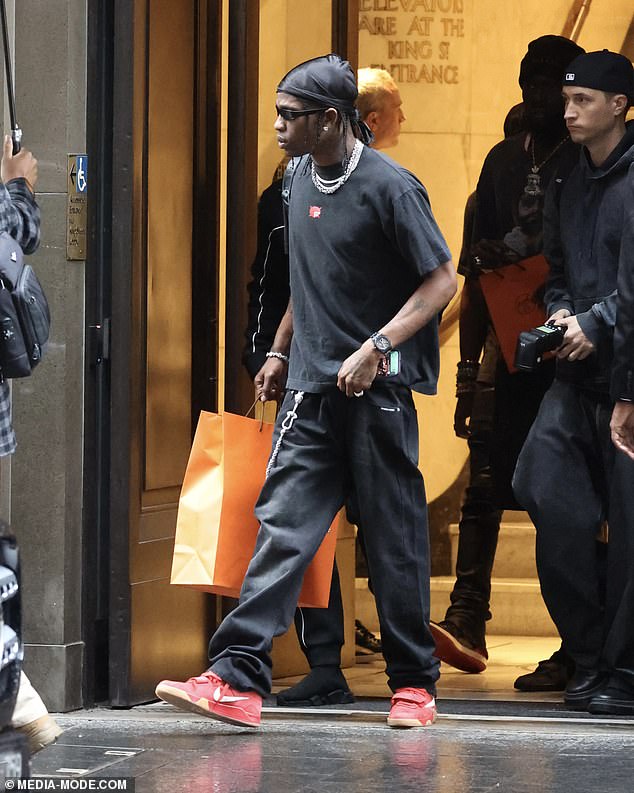 She added a pop of color to her casual ensemble with a pair of red sneakers and accessorized with an array of chunky silver jewelry.