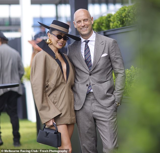 Melbourne's well-known socialites put on a cozy display as they posed arm in arm while mingling with stars at the glitzy event at Caulfield Racecourse.