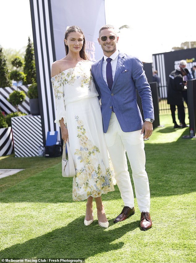 Australian high jumper Amy Pejkovic looked effortlessly chic in a floral dress as she posed alongside her AFL star boyfriend David Zaharakis.