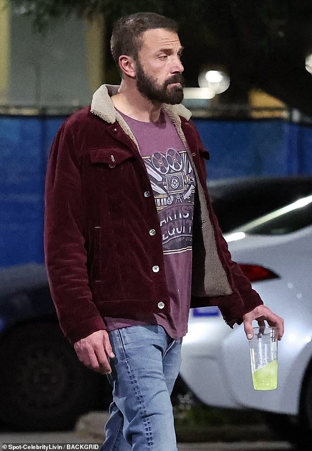 Ben kept it casual wearing a pair of light blue jeans, as well as a red patterned shirt and a dark red jacket while carrying a drink in his hand.