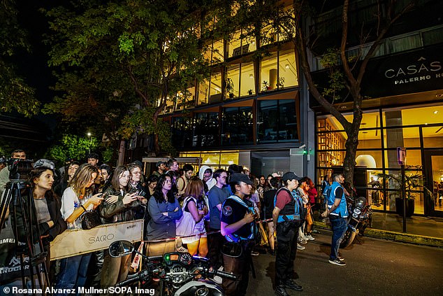 Fans wait outside the hotel on Wednesday following the star's shocking death.