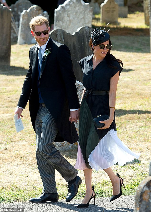 Meghan holding hands with Prince Harry at the wedding of Daisy Jenks and Charlie van Straubenzee in 2018