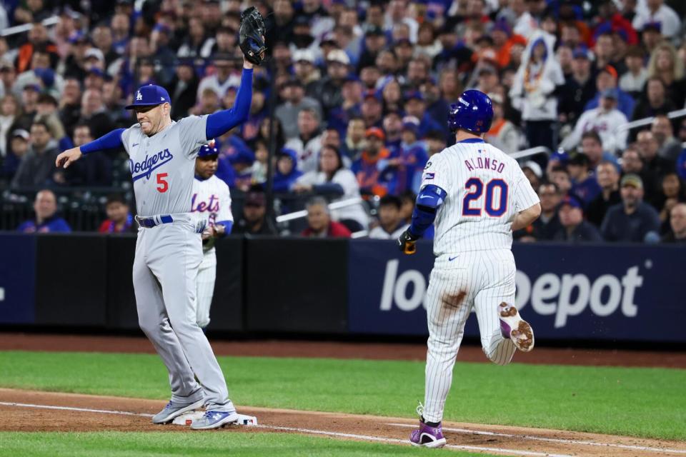 Freddie Freeman reaches out to force out New York's Pete Alonso at first base during the fifth inning on Friday.