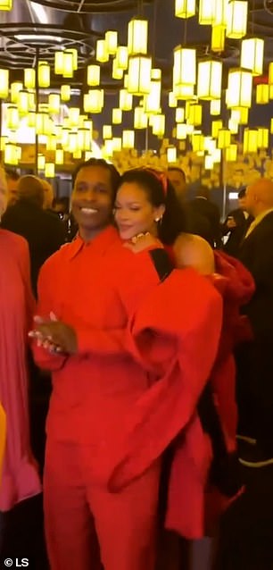 Rihanna smiled as she hugged her partner from behind, before moving to put her arm around him and nuzzle his neck for another photo.