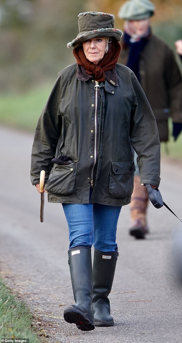 Queen Camilla occasionally dons jeans and complements blue skinny styles with Hunter Wellington boots for a stroll around Sandringham, showing off the versatility of this wardrobe staple.