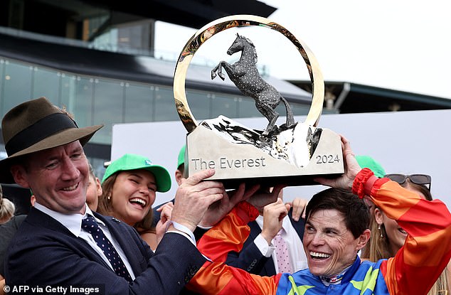 Jockey Craig Williams (pictured right), rider of Bella Nipotina and trainer Cairon Maher (pictured left) lift the 2024 Everest Trophy at Royal Randwick