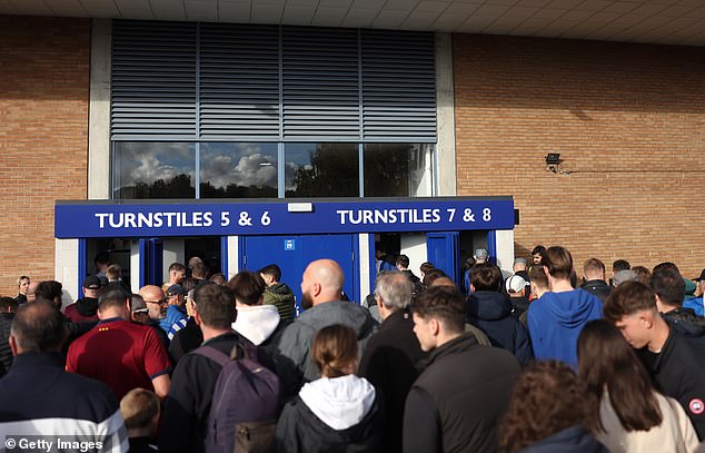 Fans pictured waiting outside Portman Road where kick-off had to be delayed.