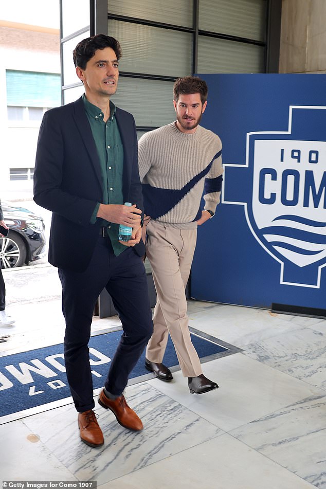 Andrew donned a stone and navy sweater paired with camel pants, a tan coat, and smart shoes.