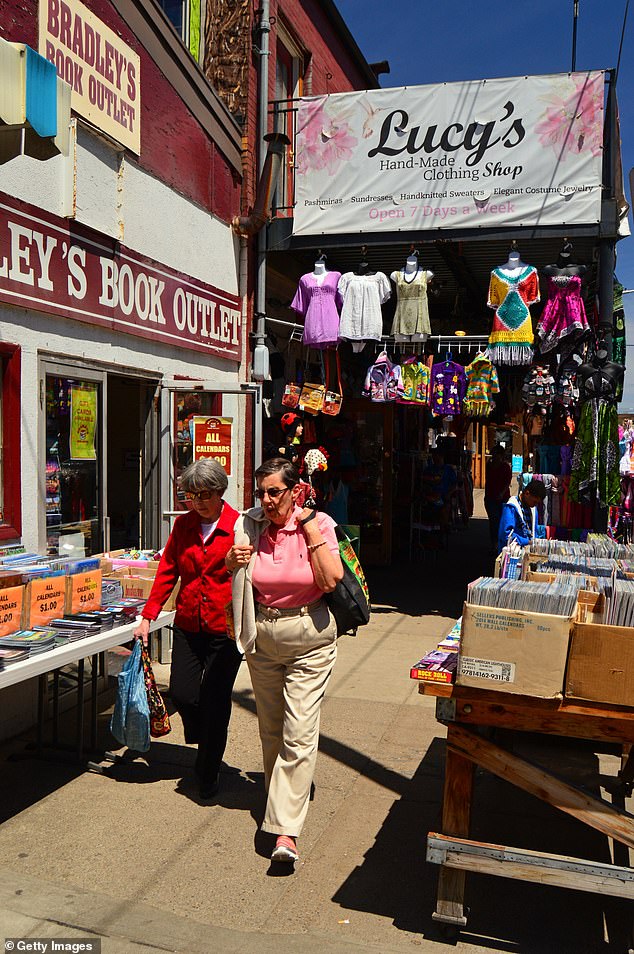 Beyond its affordability, Pittsburgh offers a rich variety of cultural attractions, dining options, and outdoor activities (pictured: Two adults shop at used clothing and book stores and sidewalk sales in the Strip shopping district of Pittsburgh).