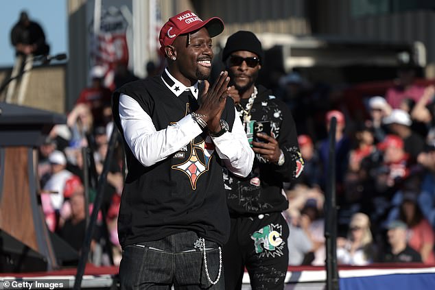 Former Pittsburgh Steelers players Antonio Brown, left, and Le'Veon Bell, right, are seen on stage as Brown spoke in support of Republican presidential candidate Donald Trump, during a campaign rally in Latrobe, Pennsylvania.