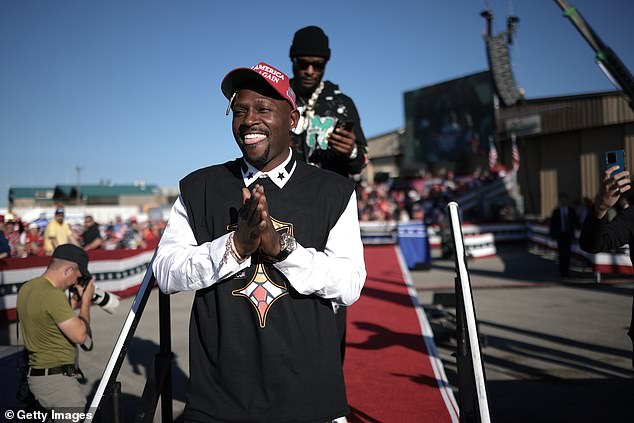 Antonio Brown sticks out his tongue while appearing to enjoy Trump's rally