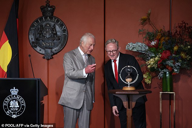 However, looking cheerful despite the long trip around Australia, he also seemed delighted to present an hourglass as a gift to mark the occasion.