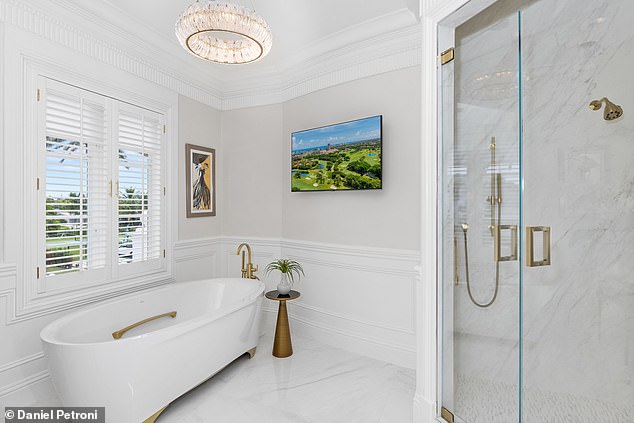 This is one of nine bathrooms that offers a combination of opulence and functionality, and features a spacious walk-in shower.