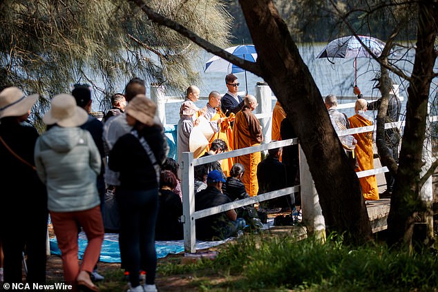 People gather for the Buddhist service held at Shearer Park in Lansvale, south-west Sydney.