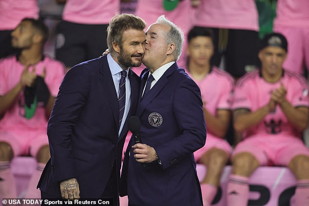 The club player sat behind David and co-owner Jorge Mas in their bright pink shirts.