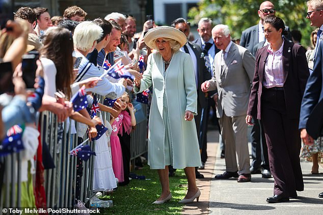 King Charles III and Queen Camilla greet the crowd during a visit to St. Thomas Anglican Church