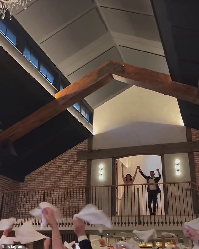 The couple made a bold entrance to their reception, dancing atop a mezzanine at the wedding venue.