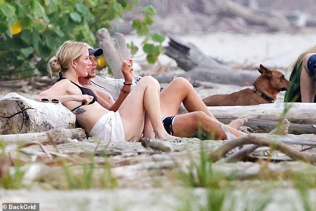 Ellie met Armando while on vacation with friends in Costa Rica over New Year's. Here she was pictured looking relaxed sunbathing with Armando before their surfing lesson.