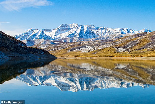 In Heber City, the median home price has soared to $982,863, up 16 percent from last year (Pictured: Snow-covered Mount Timpanogos at Deer Creek Reservoir, near Heber City, Utah)