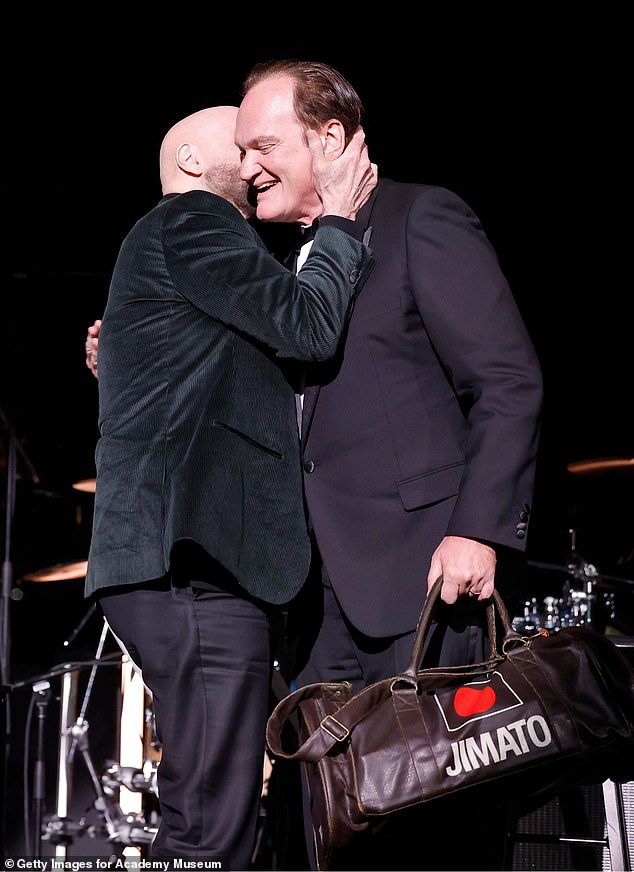 Travolta looked dapper in a black suit jacket paired with a turtleneck sweater for the evening, while Tarantino sported a tuxedo.