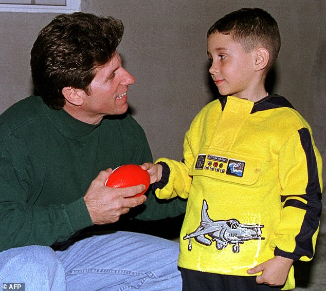 Pictured: Elián González, age six, receives a toy soccer ball as a Christmas gift from Donato Dalrymple of Fort Lauderdale, FL, at Elián's relatives' home in Miami on December 24, 1999. Dalrymple He is the fisherman who helped rescue González from the Straits of Florida. months before