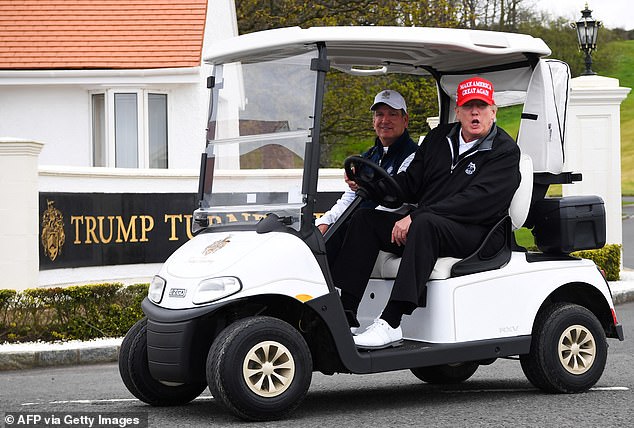 Trump drives a golf cart at Trump Turnberry Golf Courses in Scotland in May 2023