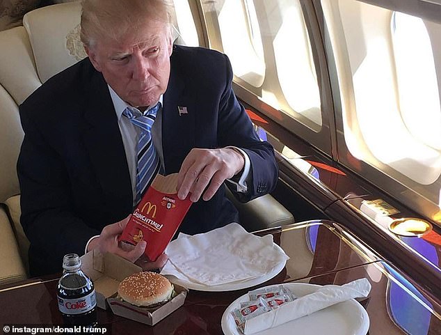 Donald Trump eating McDonald's on his plane. It looks like he ordered a Big Mac, some large fries, and a Diet Coke.