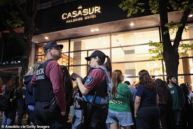 Police officers are seen standing outside the CasaSur hotel on Wednesday.