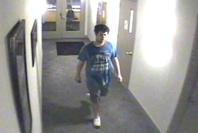 The footage, obtained and clipped by Fox News, shows a man wearing a pair of gray shorts and what appears to be a blue Penn State t-shirt holding his phone in his hands as he walks down the hallway toward the apartment's gym.