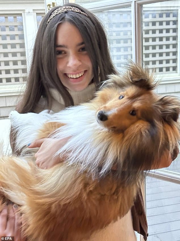 Hannah is shown hugging the family's Shetland sheepdog named Faucet, her father's favorite dog.