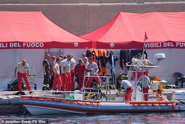 An Italian fire service diving team returns to port on the fifth day of the search and recovery operation after the luxury yacht Bayesian sank in a storm