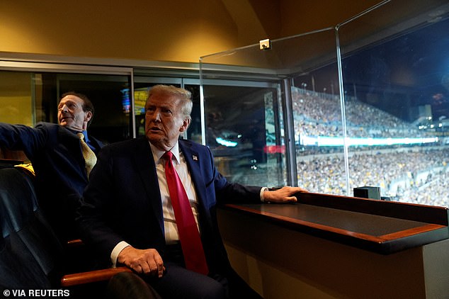 Trump is seen sitting in one of the private suites at the football game in Pittsburgh