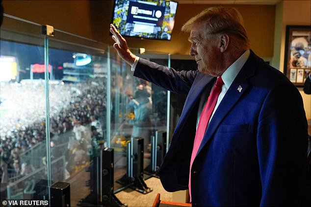 At one point Trump could be seen waving to the crows from the comfort of his private suite.