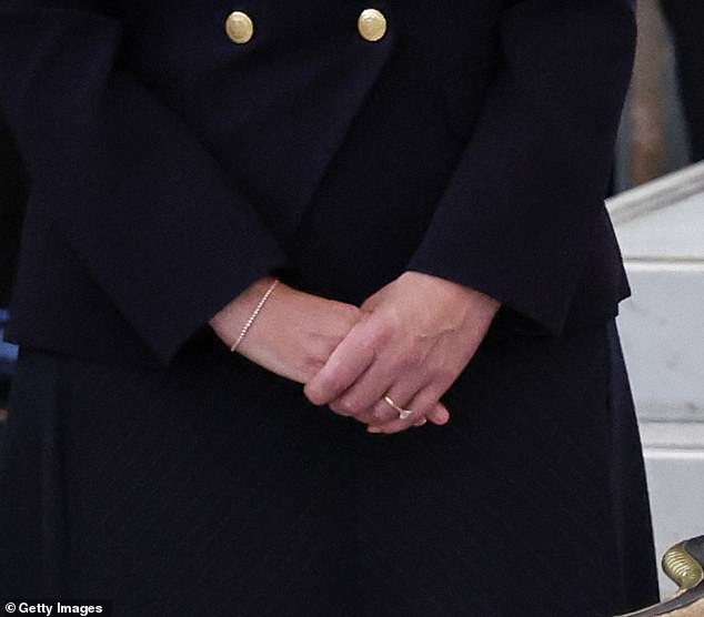 The financial services professional, 45, showed off the tennis bracelet while standing alongside the royals as they signed a visitors' book in Parliament.