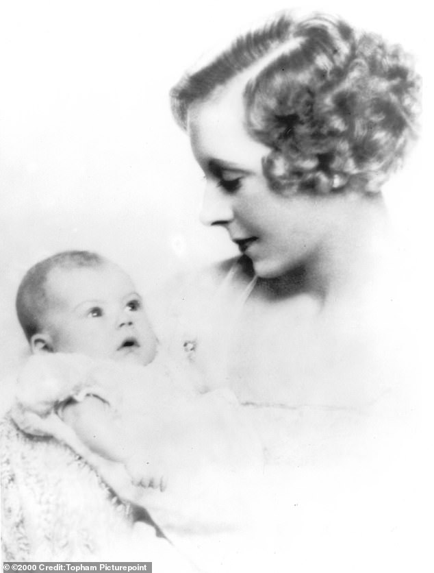 Raine as a child, photographed in the arms of her mother Barbara Cartland