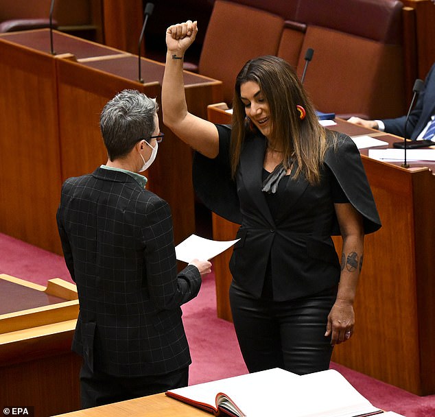 In 2022, Thorpe (right) marched onto the floor of Parliament with a Black Power salute to take the parliamentary oath.