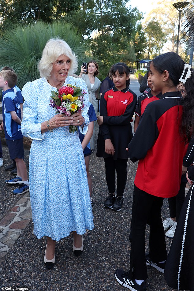 At the Botanical Garden, Camilla chatted with children from a local school, who gave her flowers.