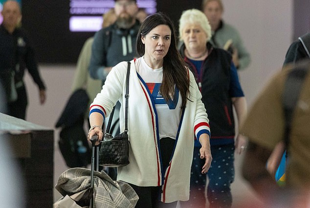 She paired the sweater with a white t-shirt.