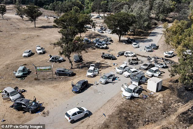 This aerial image shows abandoned and burned vehicles at the site of the October 7 attack on the Supernova desert music festival by Palestinian militants near Kibbutz Reim in the Negev Desert in southern Israel on October 13, 2023.