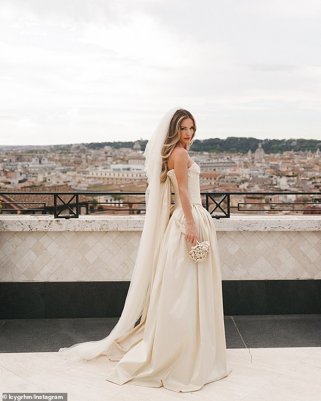 Lucy looked heavenly on her special day in a delicate off-white dress by designer Paula Nadal that featured a structured bodice that fell to the floor with a flowy skirt.