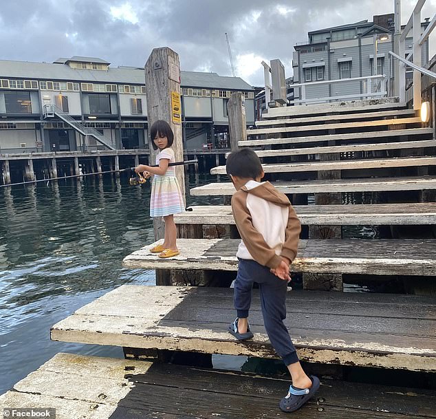 Hoai and his two children, 5-year-old Hazel and 7-year-old Mitchell, (pictured on a fishing adventure) drowned in the Georges River on Saturday.